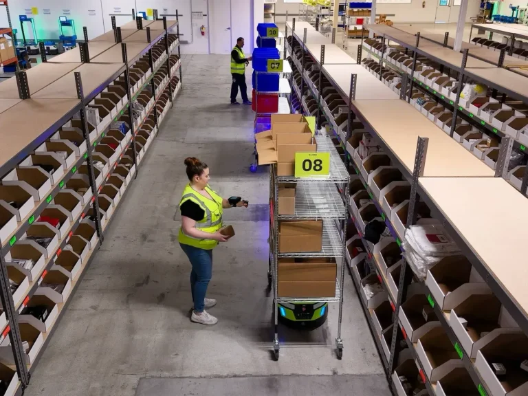 zebra symmetry fulfillment photography application in aisle multiple robots pickers overhead 2a9fc2ac15.webp